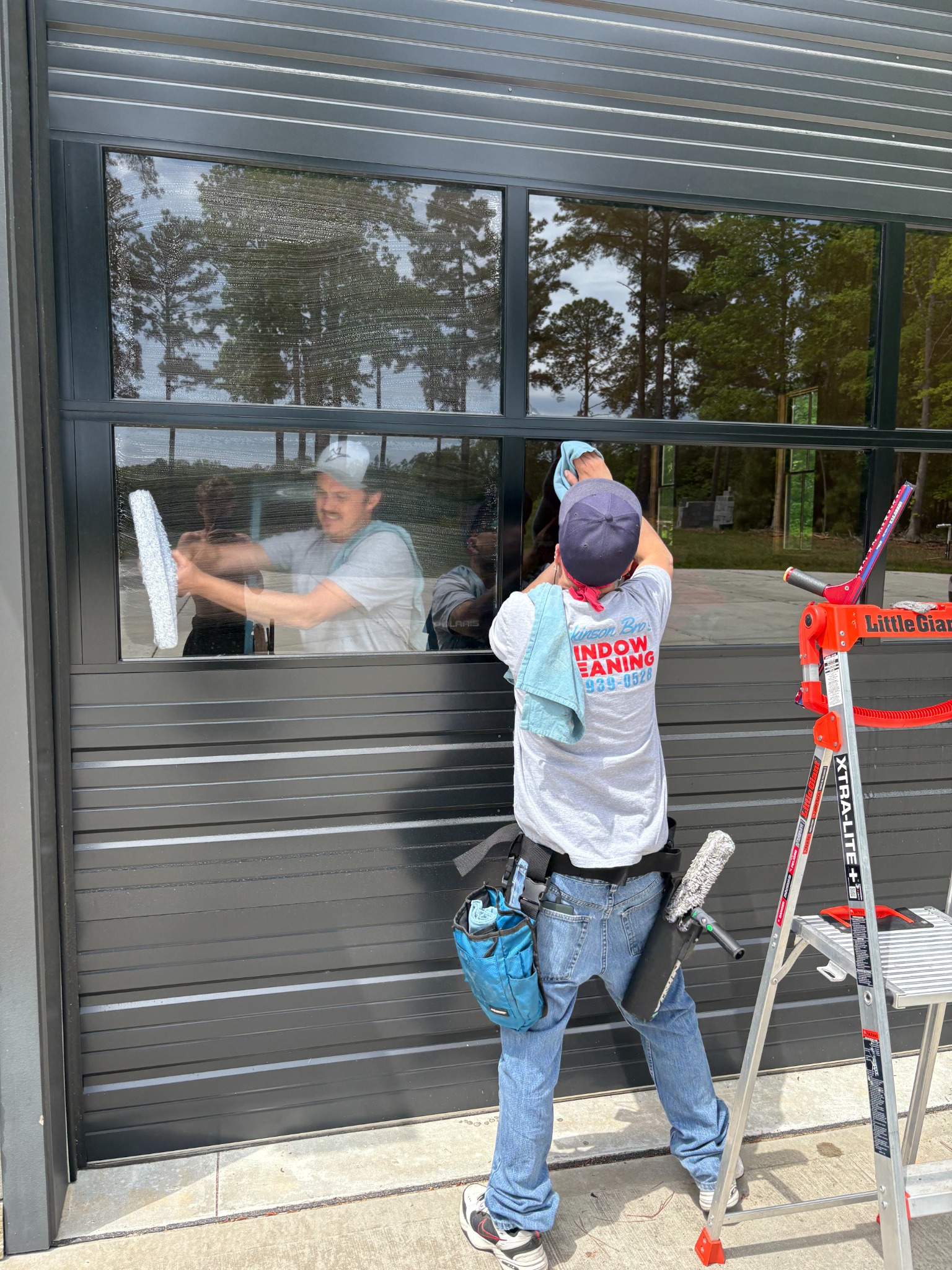Detail cleaning on modern black-framed windows